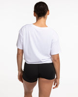 The Crop Tee - White - Odyssey - Left Chest Stacked - Black