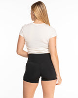 The Micro Rib Baby Tee - Natural - Ignite Barre - Center Chest - Black Printed